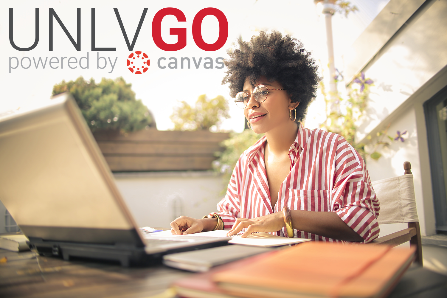 unlv go powered by canvas with a woman working in front of a laptop computer