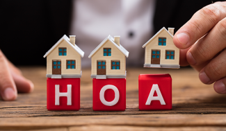 Blocks with houses on them spelling H. O. A.