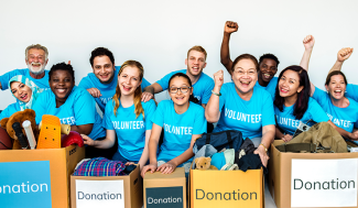 a diverse group of volunteers with donations boxes