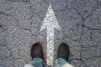 Concrete road with arrow pointing forward